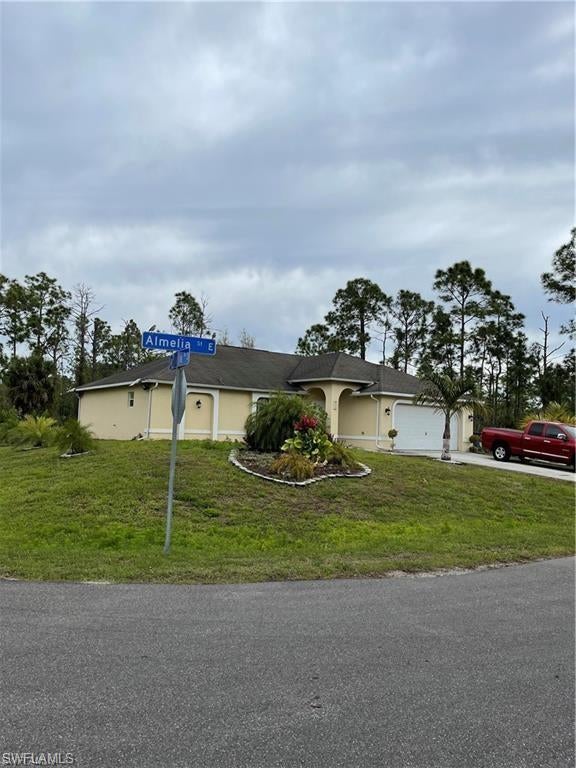 SW Florida Real Estate - View SW FL MLS #221052049 at 711 Almelia St E in LEHIGH ACRES in LEHIGH ACRES, FL - 33974